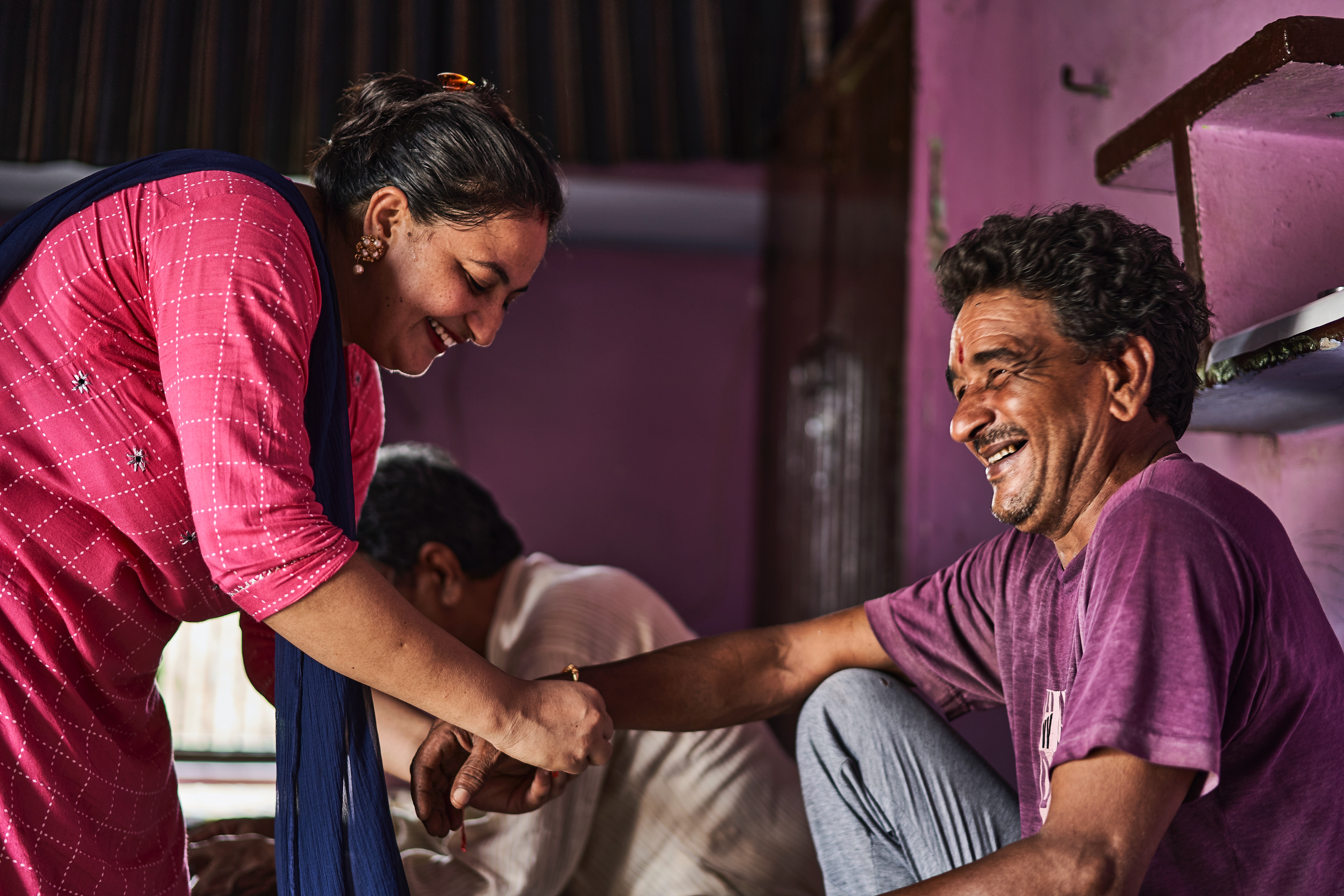 Indian sister tying rakhee to brother a symbol of family ties